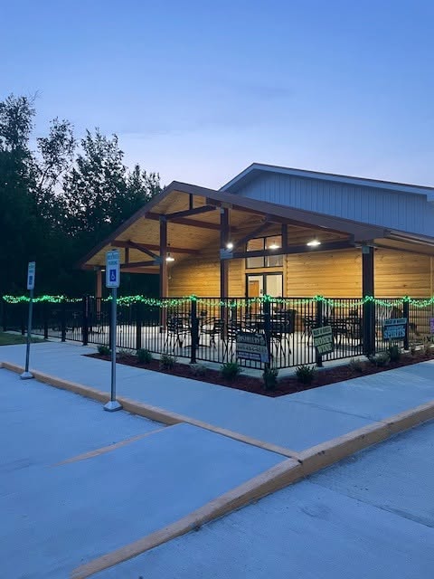 The distillery patio at dusk with green string lights